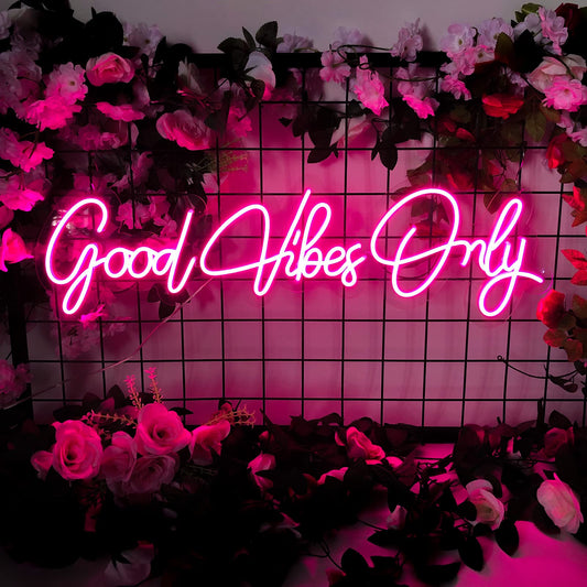 A custom neon light with the text good vibes only in pink