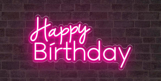A custom neon light with the text happy birthday in pink