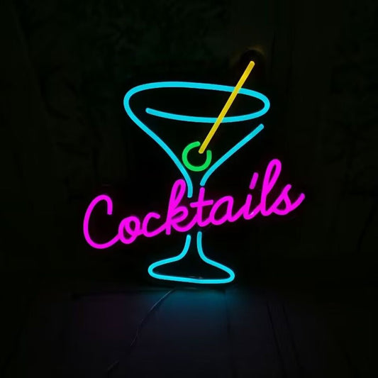 A custom neon light with the text cocktails in the middle of a martini glass