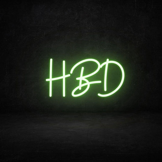 An image of a light green custom neon sign with the text HBD