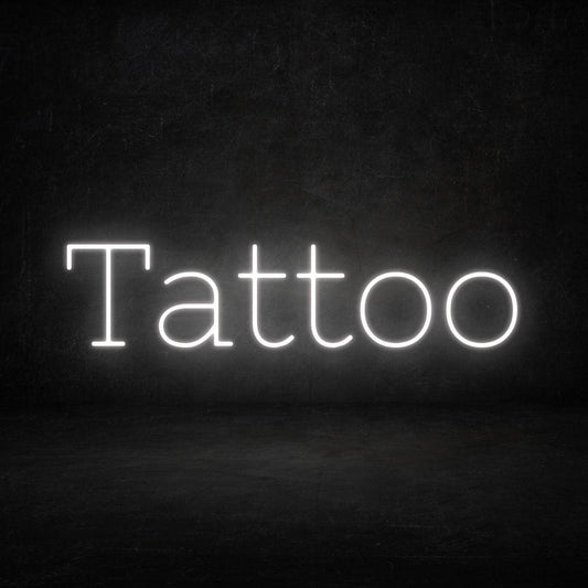 An image of a custom neon sign with the text tattoo