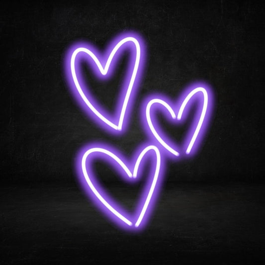 A custom neon light with an image of three purple love hearts