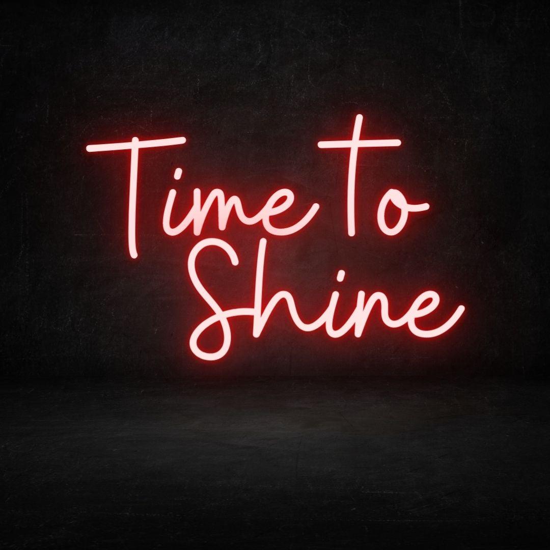 An image of a red custom neon sign with the text time to shine