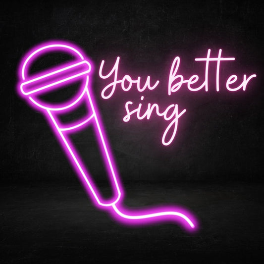 A custom neon light with the text you better sign next to a microphone