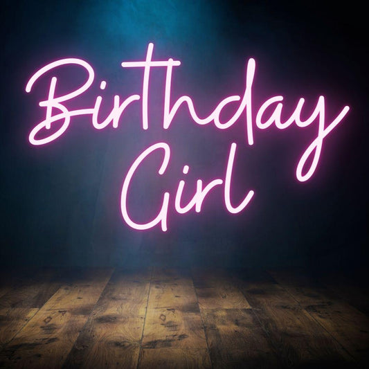 An image of a light pink custom neon sign with the text birthday girl
