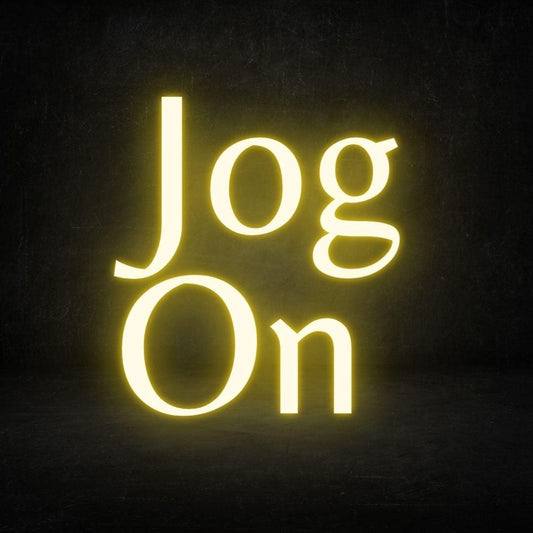 A yellow custom neon light with the text jog on